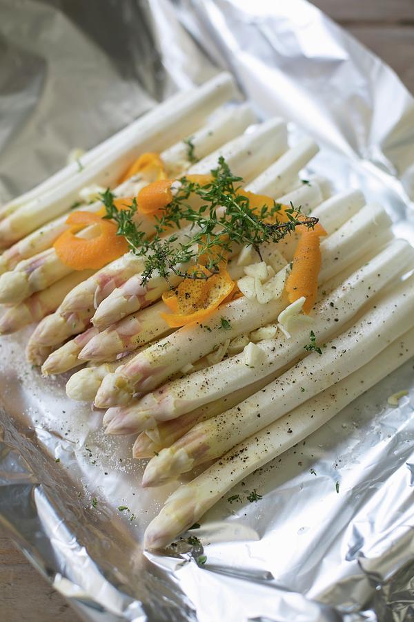 Asparagus With Orange And Thyme In Aluminium Foil Photograph by Sabine Steffens