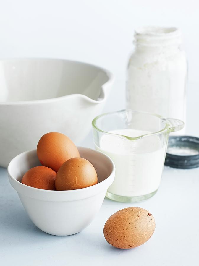 Assorted Baking Ingredients: Eggs, Milk, A Mixing Bowl Photograph by Adrian Lawrence