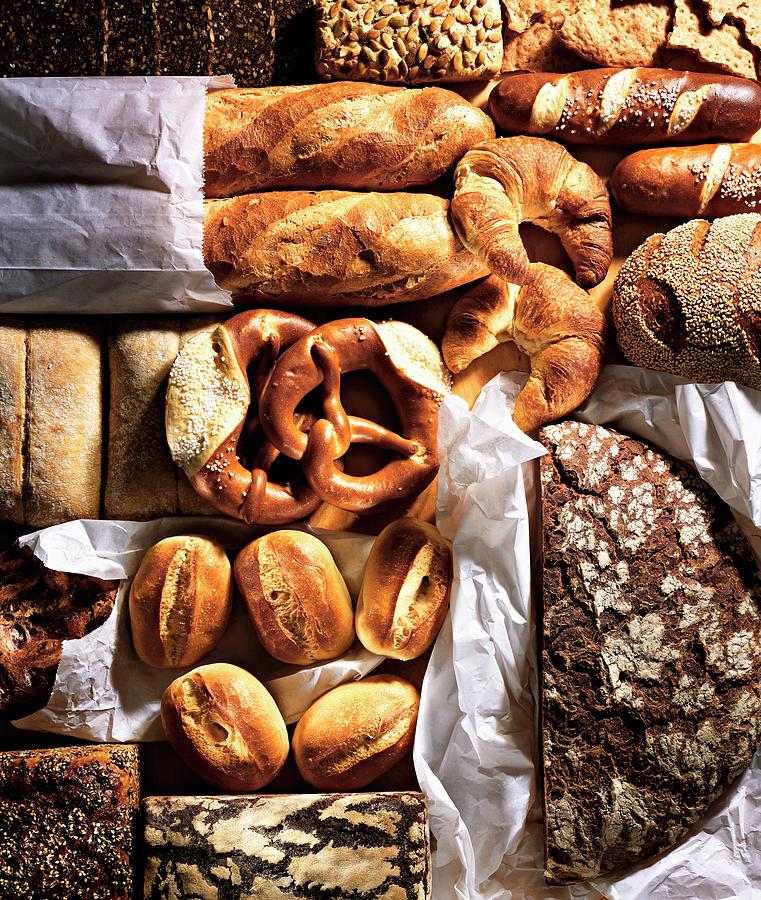 Assorted Breads, Rolls, Pretzels And Croissants On Baking Parchment Photograph by Landler/keppler
