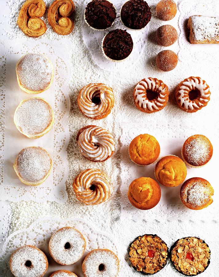 Assorted Cakes And Pastries On Paper Doilies Photograph by Landler/keppler