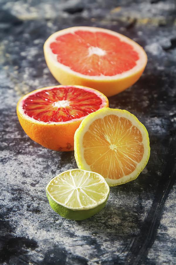 Assorted Citrus Fruit, Halved Photograph by Naltik