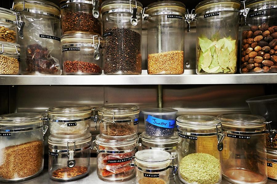 Assorted Dried Ingredients In Storage Containers On Metal Shelves Photograph by Greg Rannells