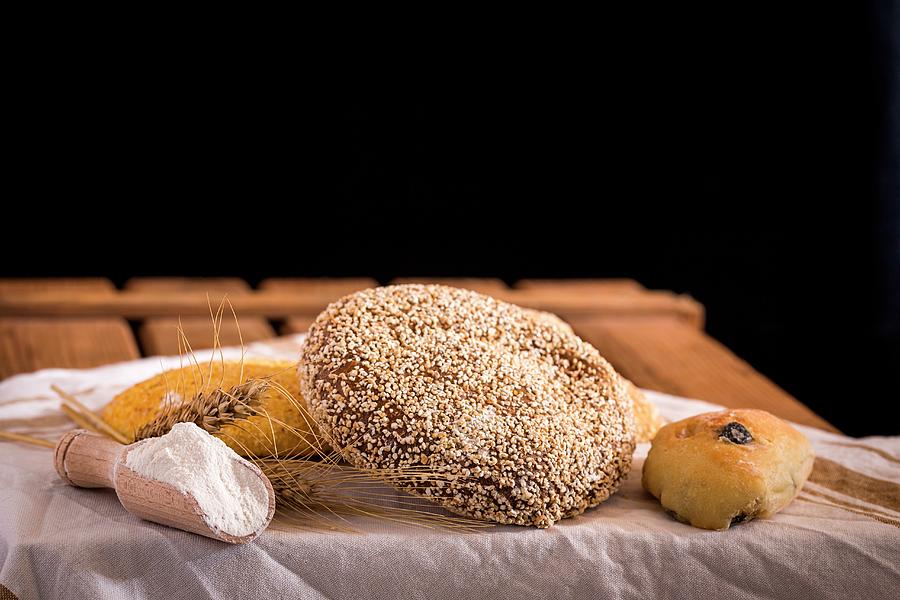Assorted Fresh Breads On An Old Wooden Table With Flour And A Napkin Photograph by Eduardo Lopez Coronado