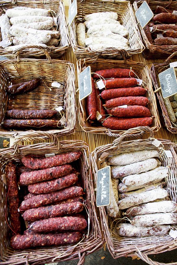 Assorted Smoked Sausages In Baskets At The Market Photograph by Moe Kafer Photography
