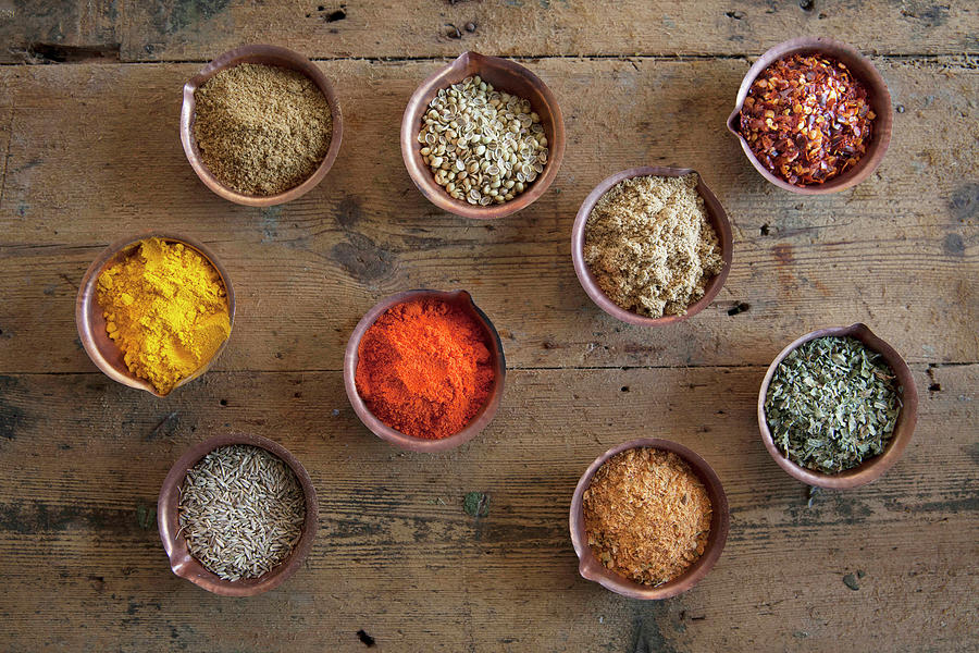 Assorted Spices In Copper Bowls Photograph by Andr Ainsworth