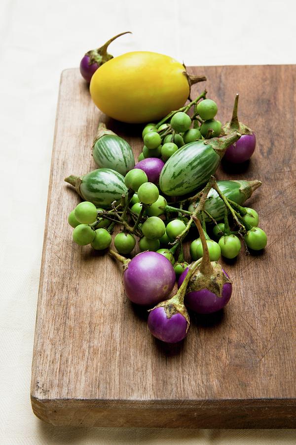 Assorted Types Of Mini Aubergine On A Wooden Board Photograph by Lscher, Sabine