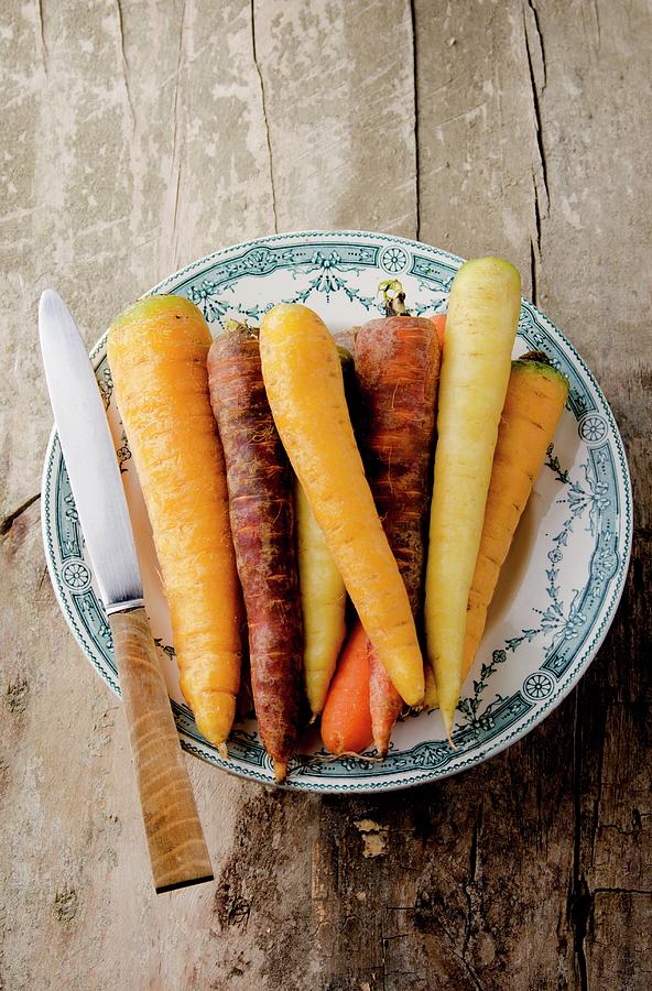 Assorted Varieties Of Carrot On An Old Plate, With A Knife Photograph by Jamie Watson