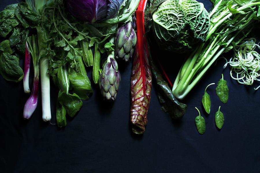Assorted Vegetables On A Black Surface Photograph by Marie Sjoberg
