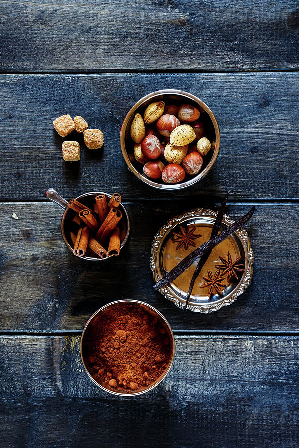 Assortment Of Aromatic Spices And Nuts For Baking Over Dark Wood Background Photograph by Yuliya Gontar