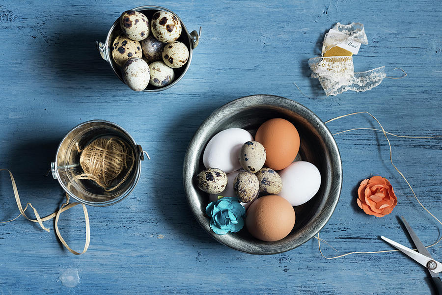 Assortment Of Eggs, Decor Elements On A Rustic Blue Wooden Background Photograph by Albina Bougartchev