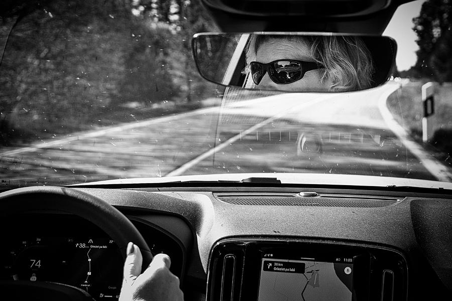 At The Steering Wheel Photograph by Normunds Kaprano