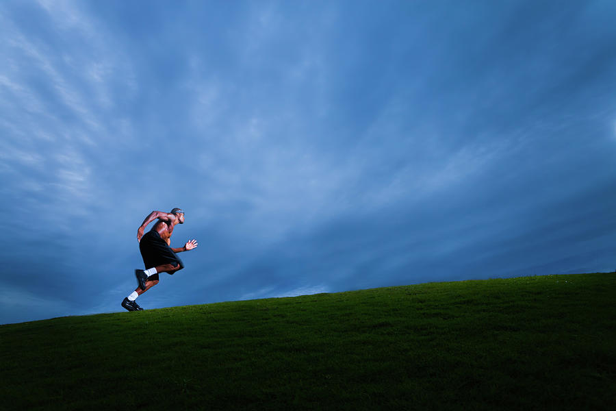 Athlete Running Up Grassy Hill Photograph by Johnnyhetfield