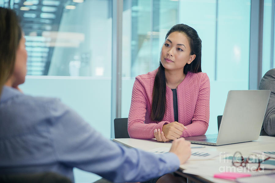 Attentive Businesswoman Listening In Meeting Photograph by Caia Image ...