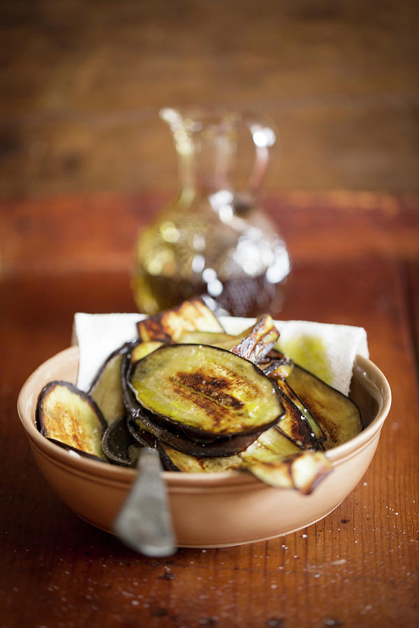 Aubergine Slices Fried In Oil Photograph by Eising Studio