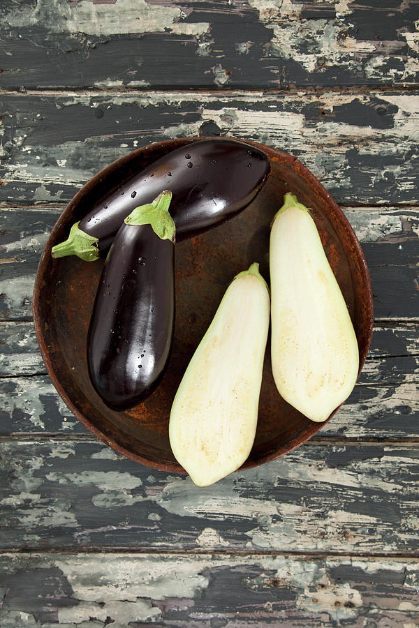 Aubergines, Whole And Halved Photograph by Ulrike Kirmse
