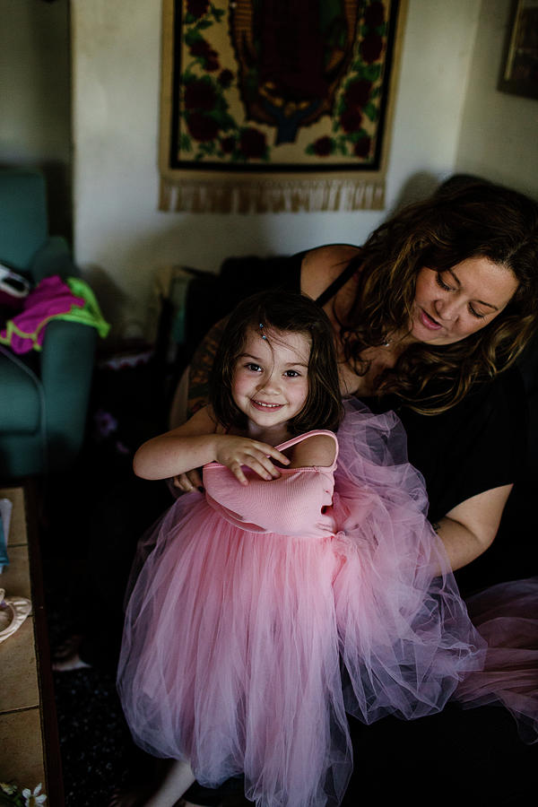 Aunt Helping Niece Put On Dress Photograph By Cavan Images 