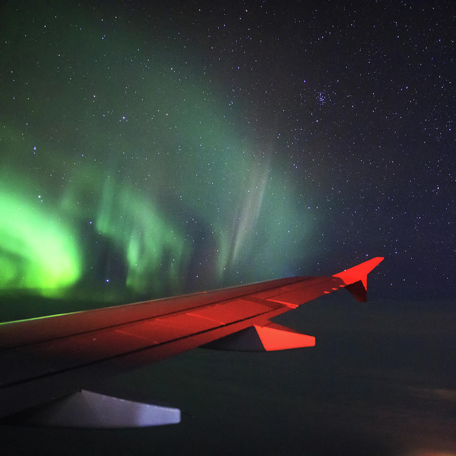 Aurora Borealis Outside Of An Airplanes Photograph by Jeff Dai