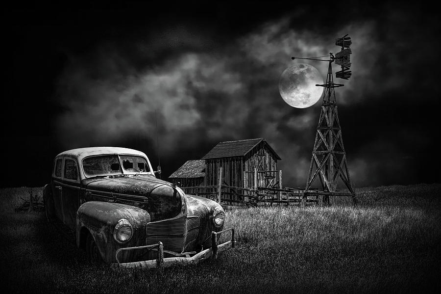Automobile and Wooden Barn with Windmill by Moon Light in Black and White Photograph by Randall Nyhof