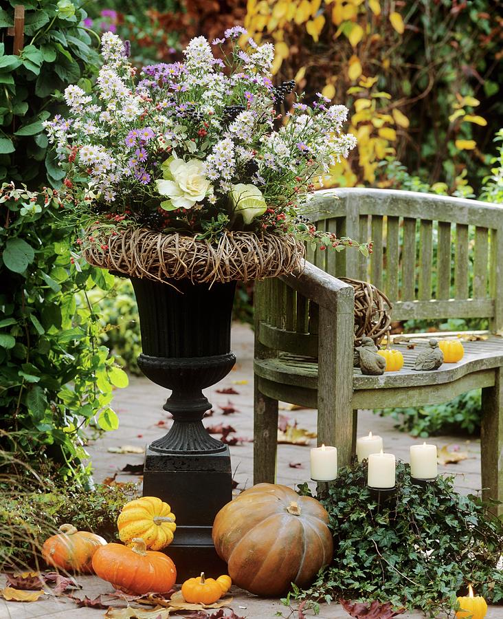 Autumn Arrangement In Iron Amphora With Willow Wreath Photograph by Friedrich Strauss