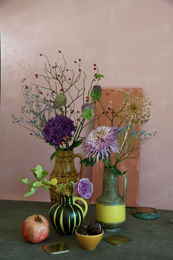 Autumn Arrangement Of Chrysanthemums, Hydrangeas, Alliums, Roses And Branches Of Rose Hips Photograph by Elisabeth Berkau