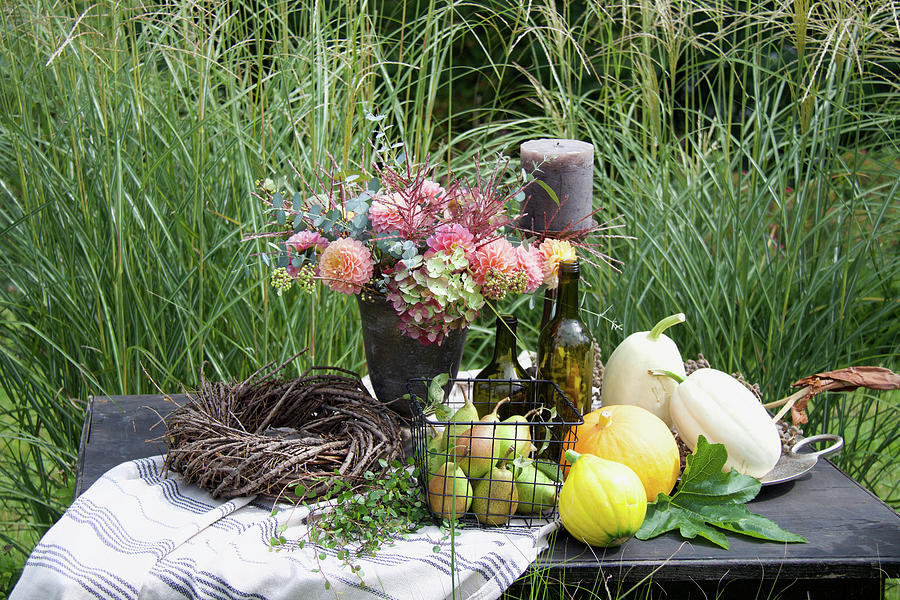 Autumn Arrangement With Pumpkins, Pears And Flower Arrangement On The Garden Table Photograph by Hilda Hornbachner