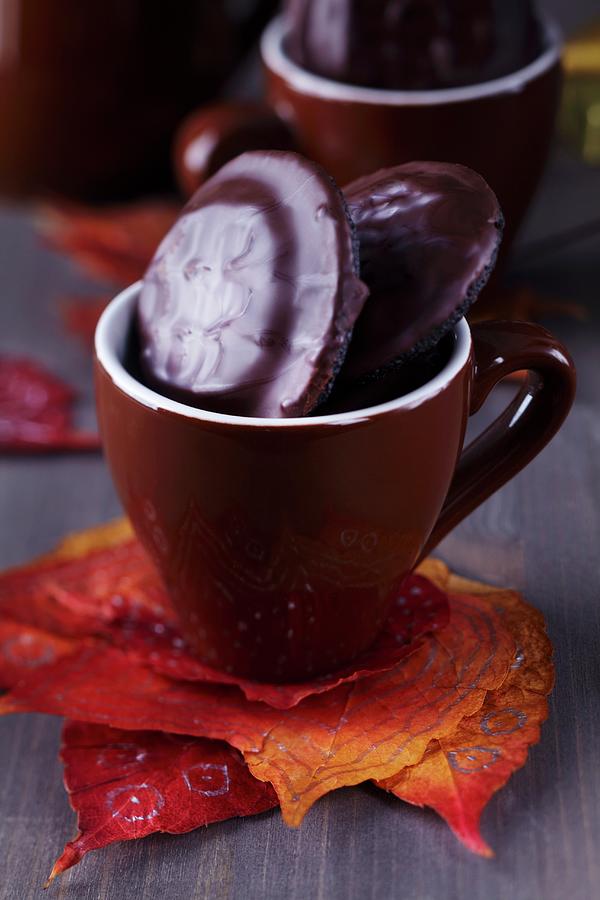 Autumn Leaves Used As Coaster For Espresso Cup Filled With Biscuits Photograph by Franziska Taube