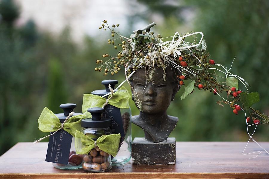 Autumn Still-life Arrangement With Wreath Of Berries On Bust And Three Storage Jars Of Nuts Photograph by Alicja Koll