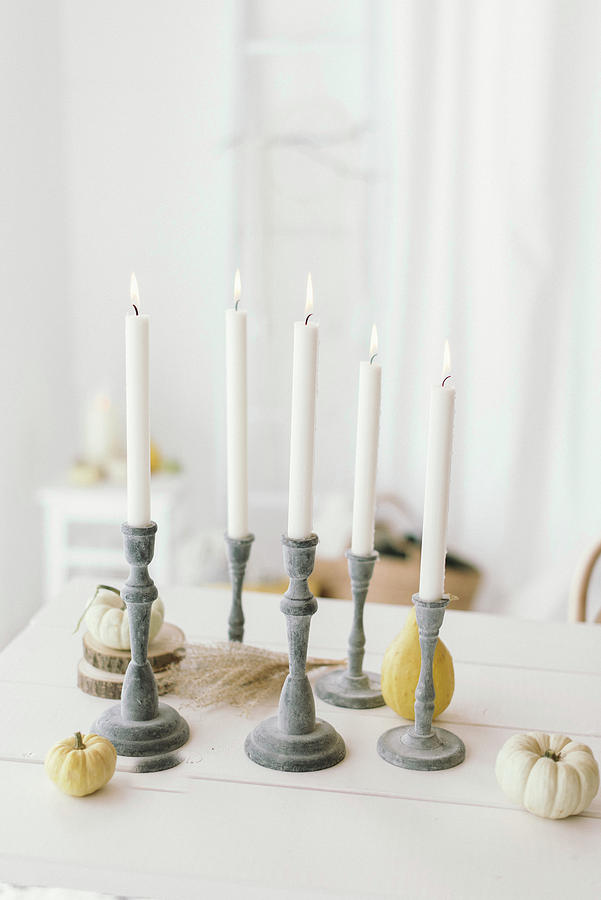 Autumnal Arrangement Of Candlesticks, Pumpkins And Wooden Discs On Table Photograph by Katja Heil