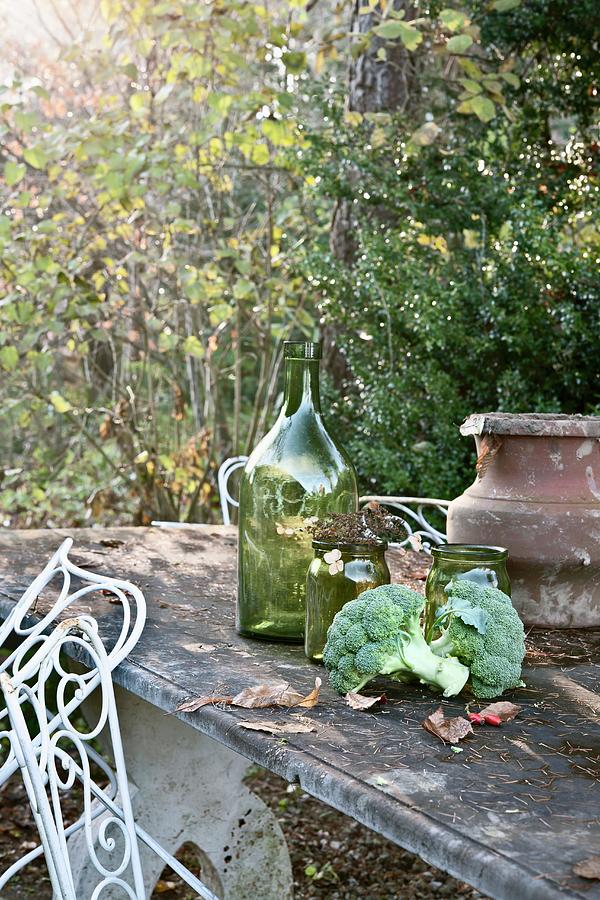 Autumnal Still-life Of Broccoli, Jars And Urn On Stone Table In Garden Photograph by Atelier Hmmerle