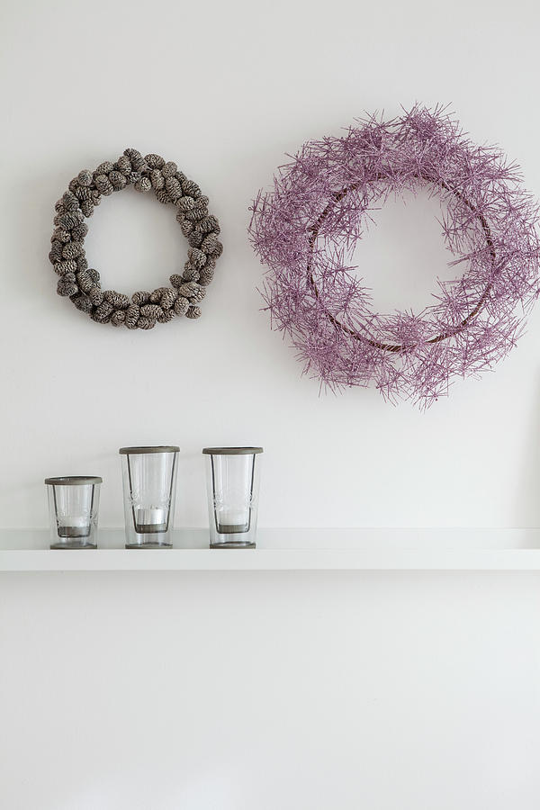 Autumnal Wreaths On White Wall Above Candle Lanterns On Shelf Photograph by Anne-catherine Scoffoni