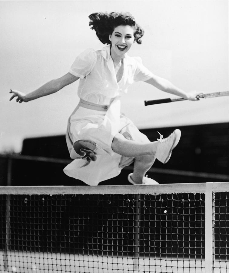 Ava Gardner Jumps Net On Tennis Court Photograph by Hulton Archive