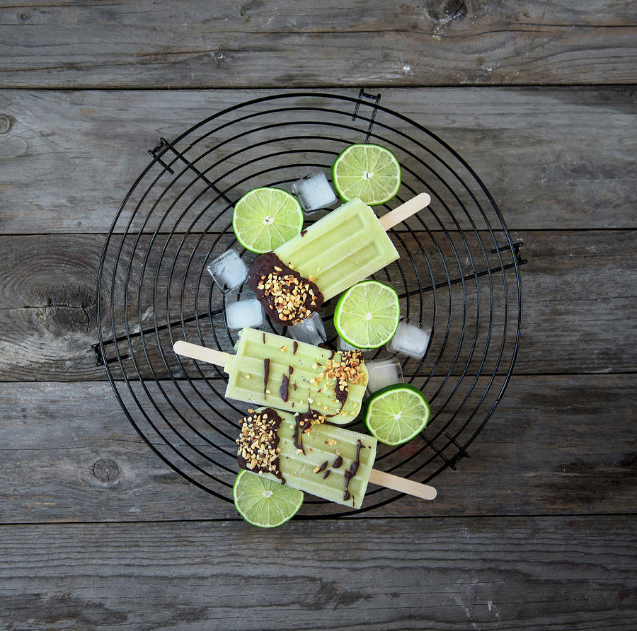 Avocado And Lime Popsicles With Chocolate Icing And Hazelnuts Photograph by Valentina T.