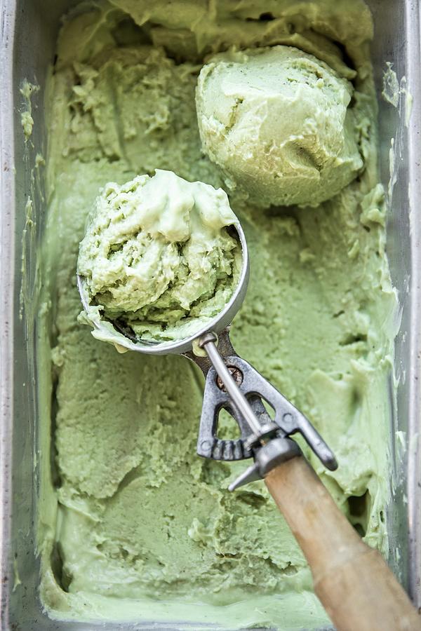 Avocado And Matcha Ice Cream In A Container With An Ice Cream Scoop Photograph by Sneh Roy