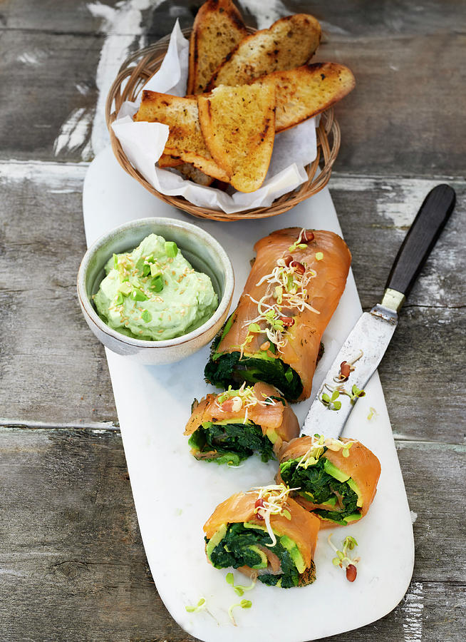 Avocado And Salmon Rolls With Oriental Herbs, A Cream Cheese And Wasabi Dip And Grilled Bread Photograph by Stefan Schulte-ladbeck