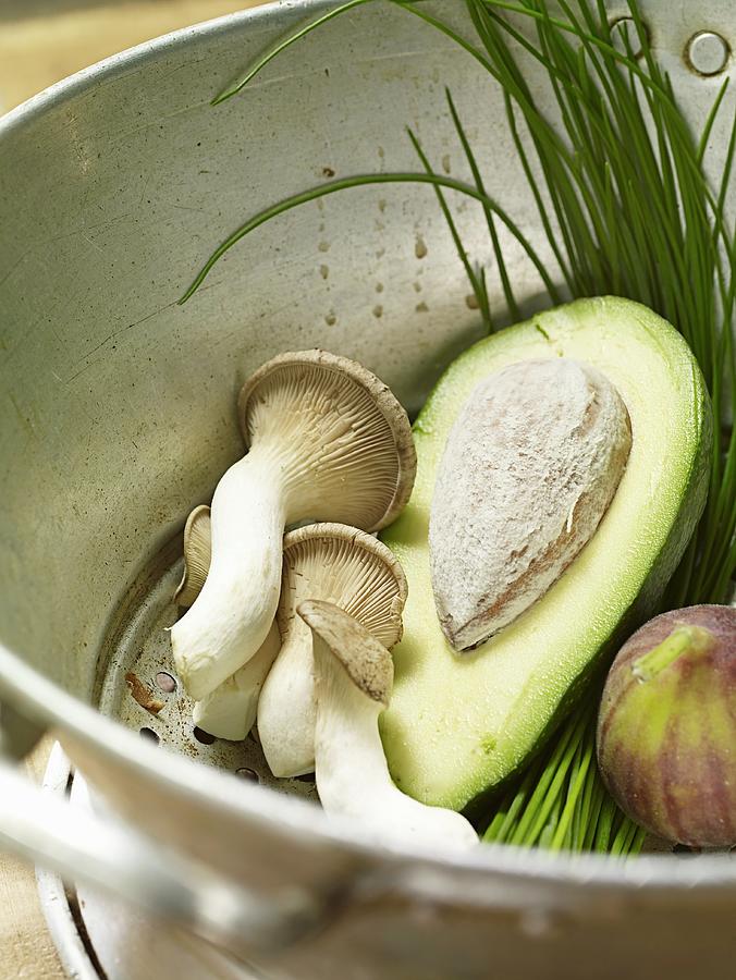 Avocado, Mushrooms, Figs And Chives In A Colander Photograph by Till Melchior
