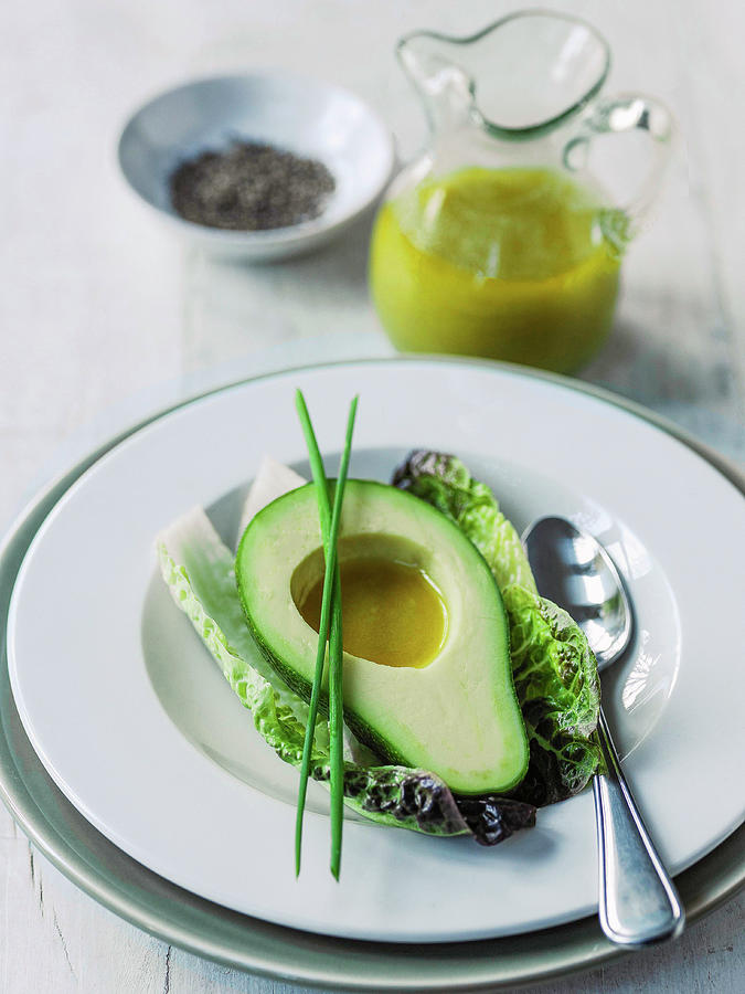 Avocado With Vinaigrette Dressing And Long Chive Garnish Photograph by Michael Paul