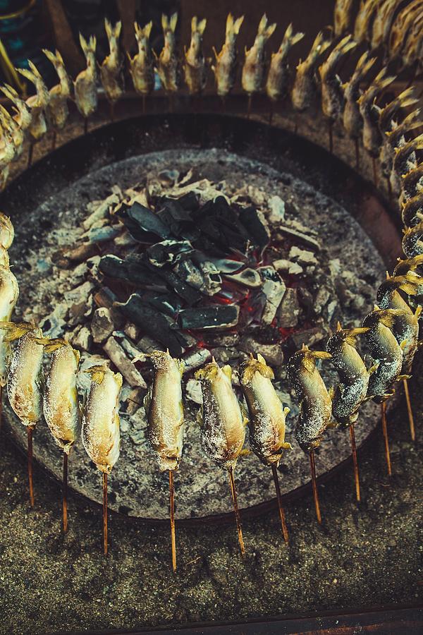 Ayu Fish On Skewers Around A Barbecue Photograph by Alfonso Calero