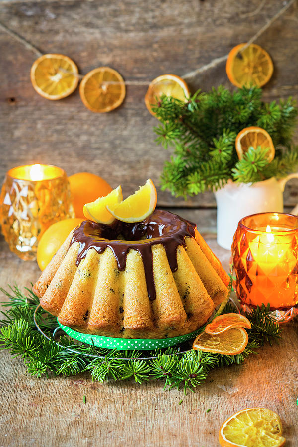 Baba With Chocolate Glaze And Oranges For Christmas Photograph by Irina Meliukh