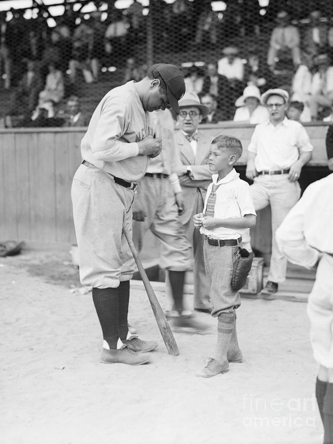 Babe Ruth Signs Baseball For Child Fan Photograph by Bettmann