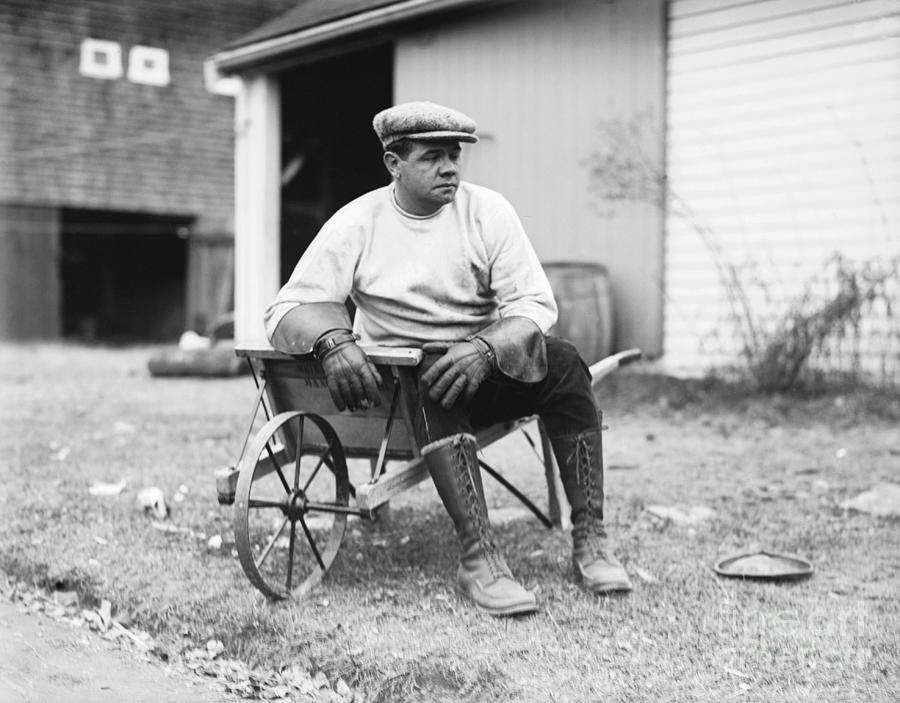 Babe Ruth Sitting On Wheelbarrow Photograph by Bettmann