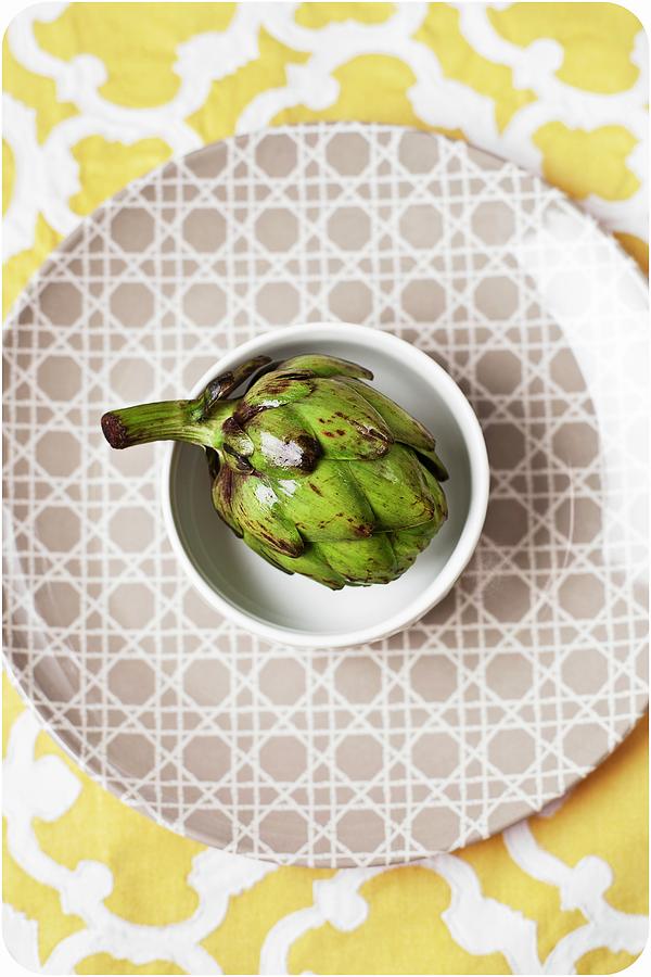 Baby Artichoke In A White Bowl On A Patterned Plate Photograph by Kailey J. Flynn Photography
