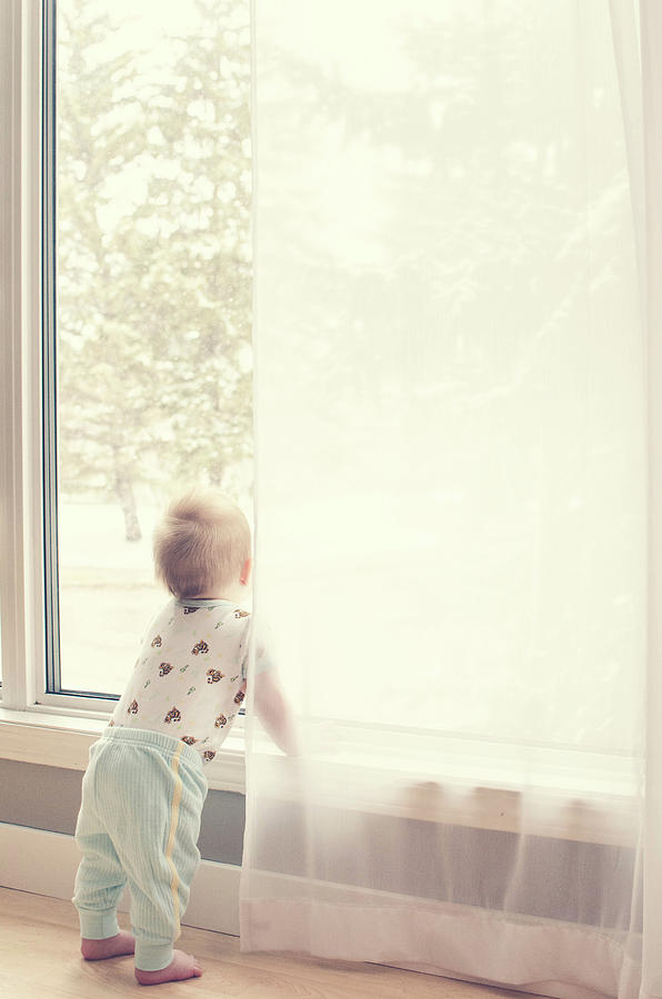 Baby At Window Watching Snow Fall Photograph by Www.reneebonuccelli.com