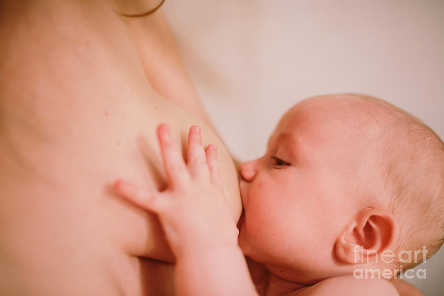 Baby feeding on the breast of his mother who breastfeeds. Photograph by Joaquin Corbalan