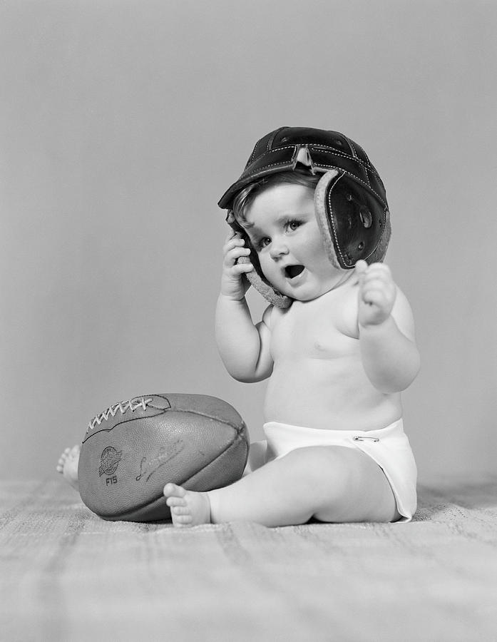 Baby Girl Wearing Leather Football Photograph by H. Armstrong Roberts