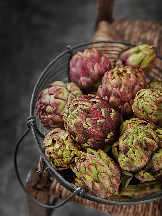 Baby Globe Artichokes On Rustic Wooden Chair Photograph by Ali Sid