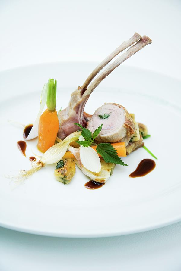 Baby Goat With Stinging Nettle Dumplings And Spring Vegetables Photograph by Michael Wissing