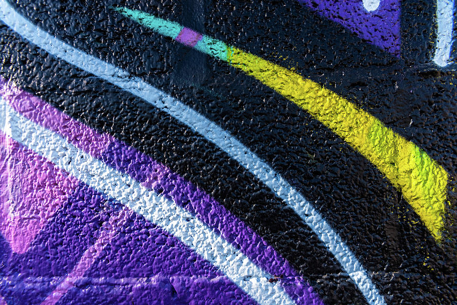 Background with wall texture painted with colorful lines. Photograph by Joaquin Corbalan