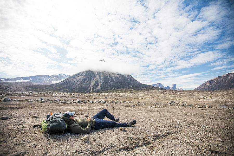 Backpacker Relaxes After A Long Day Of Hiking Through Rough Terrain ...