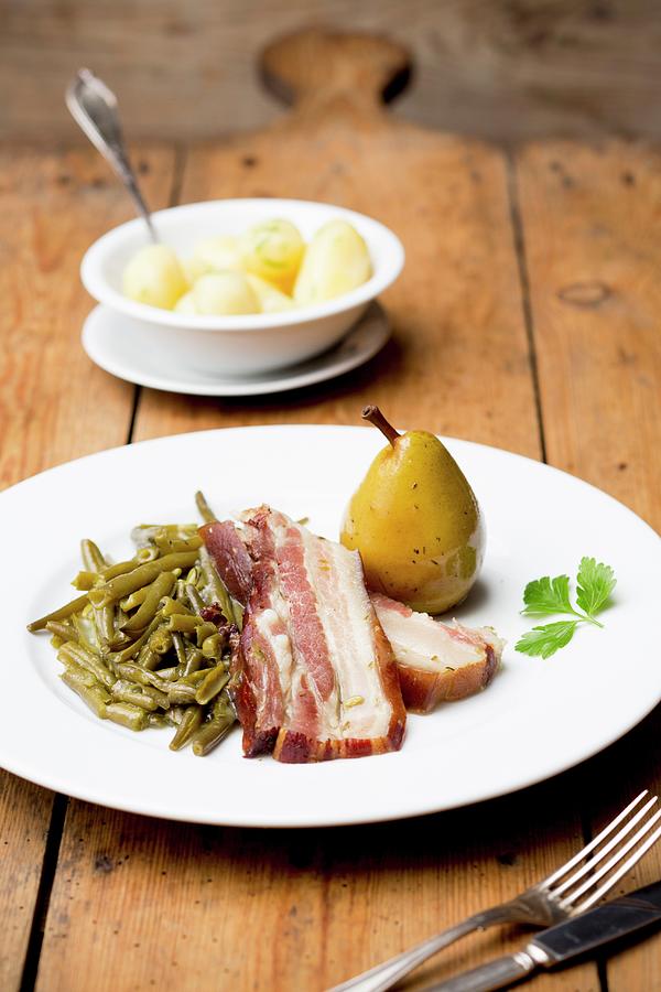 Bacon With Beans, A Pear And Salted Potatoes Photograph by Claudia Timmann