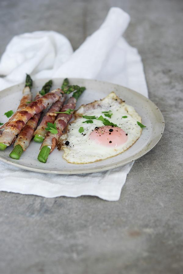 Bacon-wrapped Green Asparagus Served With A Fried Egg Photograph by Justina Ramanauskiene